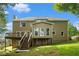 Backyard of home with stairs leading to a deck and multiple windows at 5215 Tealing Ne Dr, Roswell, GA 30075