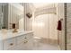 Bathroom with decorative wallpaper, single sink vanity, and neutral tile at 5215 Tealing Ne Dr, Roswell, GA 30075