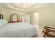 Bedroom with tray ceiling and a rocking chair, offering relaxation and style at 5215 Tealing Ne Dr, Roswell, GA 30075