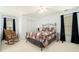 Bedroom with neutral carpet, black curtains, ceiling fan, and bed at 5215 Tealing Ne Dr, Roswell, GA 30075