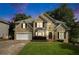 Stunning two-story home boasting well-manicured lawn, two-car garage, and inviting front entrance at 5215 Tealing Ne Dr, Roswell, GA 30075