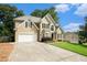 Charming two-story home with a sprawling green lawn, attached garage, and a pleasant front entrance at 5215 Tealing Ne Dr, Roswell, GA 30075