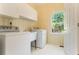 Bright laundry room with white cabinets and washer and dryer at 5215 Tealing Ne Dr, Roswell, GA 30075