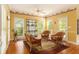 Cozy sunroom with a sitting area, wicker furniture, and outdoor access to the deck at 5215 Tealing Ne Dr, Roswell, GA 30075