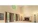 Bright living room with tall windows, a cozy fireplace, and high ceilings at 5215 Tealing Ne Dr, Roswell, GA 30075