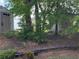View of home's wooded backyard featuring mature trees and a storage shed at 11813 Lovejoy Crossing Blvd, Hampton, GA 30228