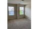 Light-filled bedroom with neutral carpet and two windows providing ample natural light at 11813 Lovejoy Crossing Blvd, Hampton, GA 30228