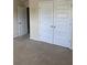 Cozy bedroom with carpet and ample closet space, perfect for organized living at 11813 Lovejoy Crossing Blvd, Hampton, GA 30228