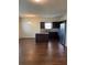 Eat-in kitchen features dark wood cabinets, stainless steel refrigerator, granite countertops and center island at 11813 Lovejoy Crossing Blvd, Hampton, GA 30228