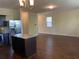 Kitchen view showcases a center island open to a spacious living area with bright natural light at 11813 Lovejoy Crossing Blvd, Hampton, GA 30228