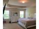 Primary bedroom with trey ceiling, carpet, large windows, and a mirrored dresser at 11813 Lovejoy Crossing Blvd, Hampton, GA 30228