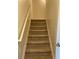 Carpeted staircase with white railing leading to the upper level, offering easy access at 11813 Lovejoy Crossing Blvd, Hampton, GA 30228