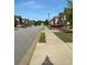 Street view showing homes in the neighborhood with sidewalks on a sunny day at 11813 Lovejoy Crossing Blvd, Hampton, GA 30228