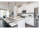 Bright white kitchen featuring stainless steel appliances, quartz countertops, and modern pendant lighting at 2670 Brookview Nw Ln, Atlanta, GA 30318