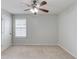 Carpeted bedroom features neutral walls, single window, and flush-mount ceiling fan with lights at 2725 Sedgeview Way, Buford, GA 30519