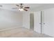 Neutral bedroom features carpet, a ceiling fan with light, and white doors at 2725 Sedgeview Way, Buford, GA 30519