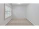 A bright bedroom featuring plush carpeting, light gray paint, and a well-lit window at 2725 Sedgeview Way, Buford, GA 30519