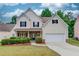Charming two-story home with a well-manicured lawn and a two-car garage at 2725 Sedgeview Way, Buford, GA 30519