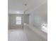 Bright upstairs hallway with neutral carpet and paint, a window, and wall lighting at 2725 Sedgeview Way, Buford, GA 30519