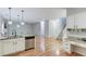Open kitchen with stainless steel appliances, granite countertops, and hardwood floors at 2725 Sedgeview Way, Buford, GA 30519