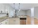 Open kitchen with breakfast bar island, stainless steel dishwasher, and granite countertops at 2725 Sedgeview Way, Buford, GA 30519