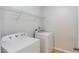 Functional laundry room featuring a washer, dryer, and shelving at 2725 Sedgeview Way, Buford, GA 30519