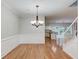 Open-concept living area with hardwood floors, and staircase access at 2725 Sedgeview Way, Buford, GA 30519