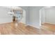 Open-concept with hardwood floors, arched doorways, and a view of the kitchen at 2725 Sedgeview Way, Buford, GA 30519