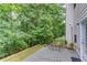 Patio with seating area and views of the backyard's lush trees and hillside at 2725 Sedgeview Way, Buford, GA 30519
