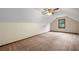 Finished attic space with carpet, sloping ceilings, and window at 2790 Shiloh Way, Snellville, GA 30039