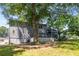 Backyard view, landscaped with mature trees, a lawn, and a deck at 2790 Shiloh Way, Snellville, GA 30039