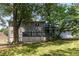 View of the home's backyard with a deck and mature trees providing shade at 2790 Shiloh Way, Snellville, GA 30039