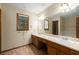 Bathroom featuring double sinks, marble countertop vanity, and a large framed mirror at 2790 Shiloh Way, Snellville, GA 30039