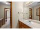 Bathroom with a vanity, large mirror, and doorways leading to other areas at 2790 Shiloh Way, Snellville, GA 30039