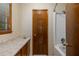 Bathroom area featuring a vanity, a window with blinds, and a door to a shower/tub area at 2790 Shiloh Way, Snellville, GA 30039