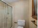 Modest bathroom featuring a glass shower door, standard toilet, and window for natural light at 2790 Shiloh Way, Snellville, GA 30039