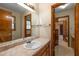 Traditional bathroom featuring a single sink vanity, large mirror, and access to other rooms at 2790 Shiloh Way, Snellville, GA 30039