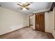 Bedroom featuring a ceiling fan, closet, and a doorway leading to another room at 2790 Shiloh Way, Snellville, GA 30039