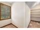 Carpeted closet space with built-in shelving and a window providing natural light at 2790 Shiloh Way, Snellville, GA 30039