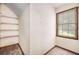 Small closet space with built-in shelving and a window providing natural light at 2790 Shiloh Way, Snellville, GA 30039