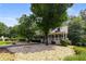 Home featuring a charming front yard with mature trees and landscape, offering a peaceful setting at 2790 Shiloh Way, Snellville, GA 30039