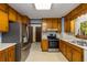Galley kitchen with wood cabinets and stainless steel appliances at 2790 Shiloh Way, Snellville, GA 30039