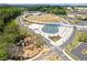 Aerial view of the park featuring a playground, water feature, and green spaces at 527 Main St, Suwanee, GA 30024