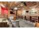 Finished basement featuring a bar, TVs, seating and exposed duct work at 527 Main St, Suwanee, GA 30024