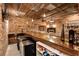 Basement bar with exposed brick walls, wood bar, and vintage lighting offers a unique entertaining space at 527 Main St, Suwanee, GA 30024
