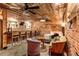 Finished basement featuring a bar and lounge area with brick walls and vintage decor at 527 Main St, Suwanee, GA 30024