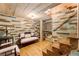 Basement lounge area with colorful wood accent wall and staircase at 527 Main St, Suwanee, GA 30024