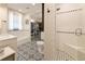 Bathroom with subway tile, a tub, and a walk in shower. It has a view to a large walk in closet at 527 Main St, Suwanee, GA 30024