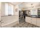 Well-appointed bathroom with tub, patterned floor tiles and a walk-in closet with custom organization at 527 Main St, Suwanee, GA 30024