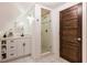 Modern bathroom featuring a glass enclosed shower, vanity and dark wooden door at 527 Main St, Suwanee, GA 30024